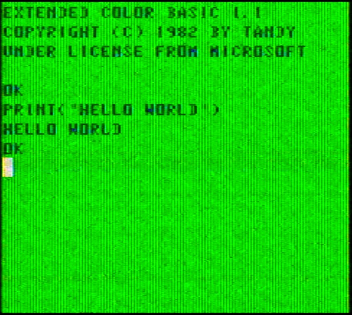 A screenshot of the CoCo 2's bootup screen, along with an executed line of code which printed 'hello world'